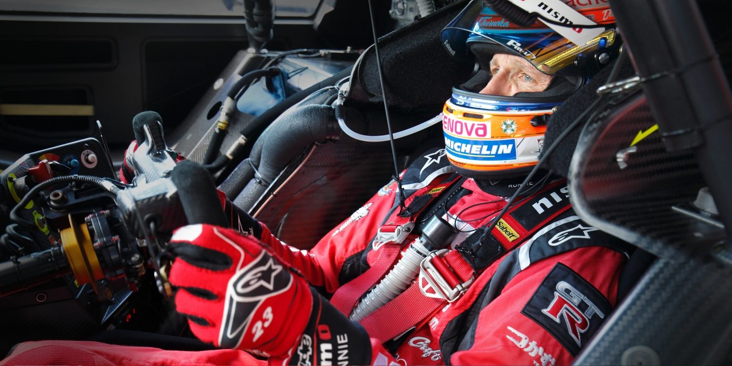 Racer in driver's cockpit of race car
